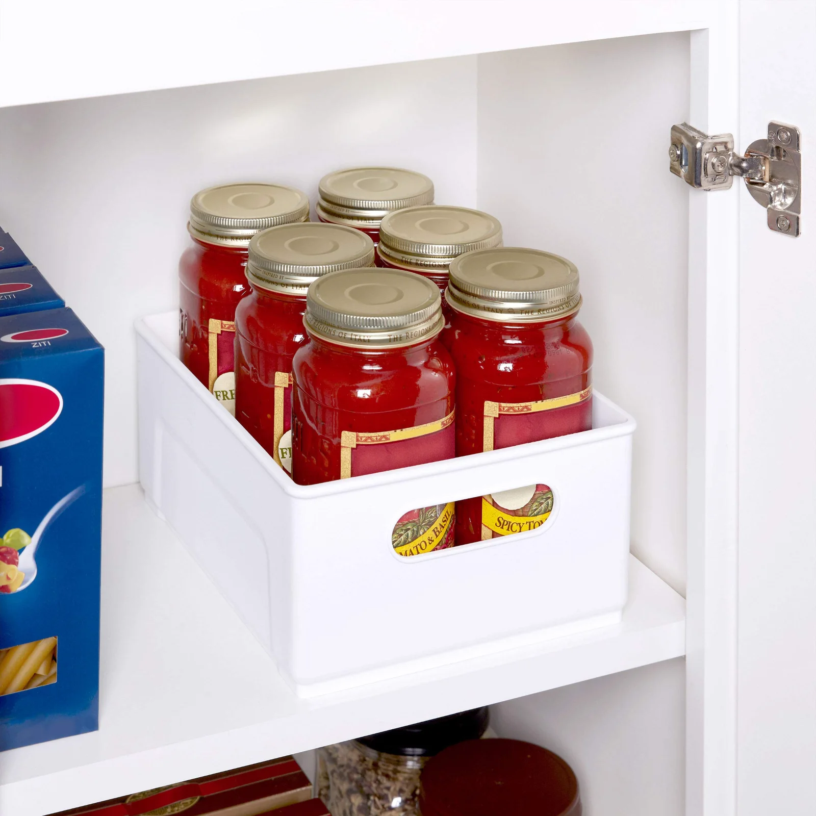 A handled bin on a high shelf, pulled down like a drawer instead of emptied blind.