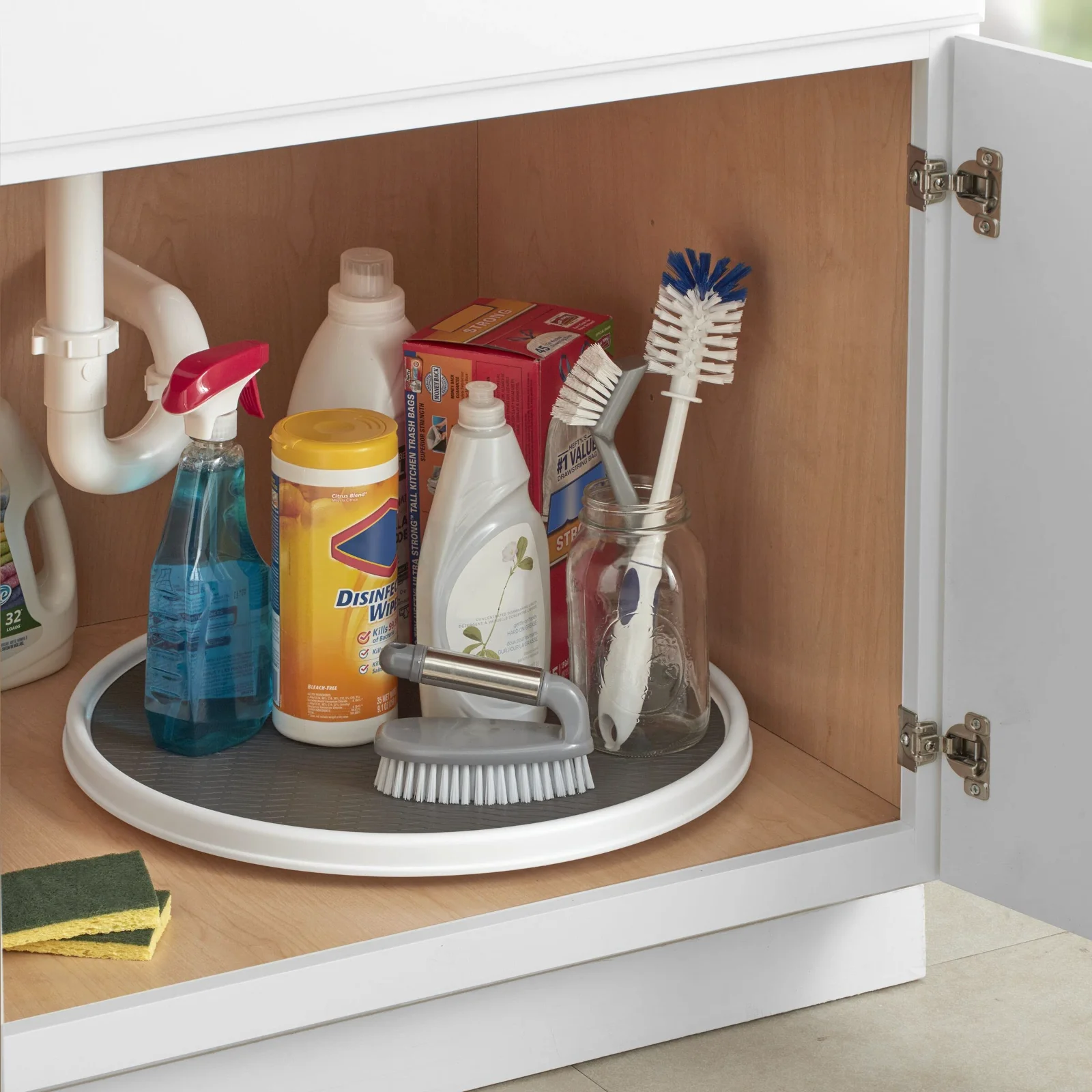A turntable loaded with cleaning supplies: the tray turns, the base and the bottles stay put.
